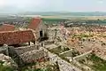 House ruins along the wall and town below