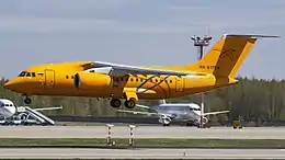 A bright-orange-coloured passenger jet about to land