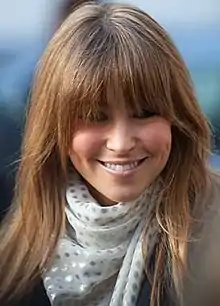 Head and shoulders view of a young woman with brown hair