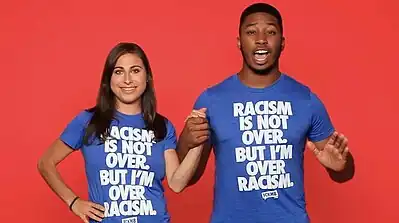 Models wear "Racism is not over, but I'm over racism" T-shirts from FCKH8.