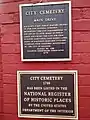 Plaques in front of the cemetery