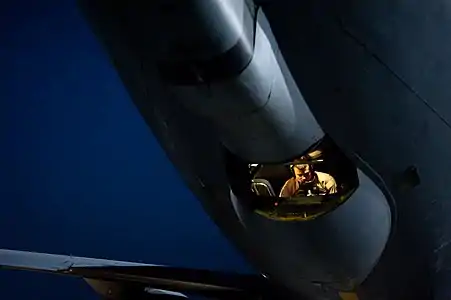 A boom operator in a USAF KC-135 conducts a preflight inspection in the boom pod prior to a mission in the Middle East.