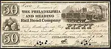 Philadelphia and Reading Railroad Company 50 dollar bill. Bill has several small circular holes punched through the signatures of the Treasurer and Engineer. Images include Liberty, seated, with shield, caduceus, and sailing vessels; a busy railway station with cars on four different tracks; and a horse.