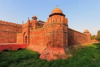 Fortress walls and a gate in red stone