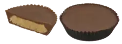 A whole Reese's Peanut Butter Cup next to a half Reese's Peanut Butter Cup showing the peanut butter filling in the middle of the Hershey's chocolate.