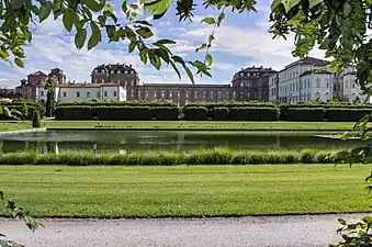 The palace with its gardens. The 17th-century wing on the right (in white plaster) while the 18th century wing is in the center (with a brick exterior).