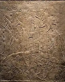 Ashurbanipal's campaign against Elam is triumphantly recorded in this relief showing the destruction of Hamanu. Here, flames rise from the city as Assyrian soldiers topple it with pickaxes and crowbars and carry off the spoils. British Museum.