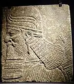 Winged genius head relief from the palace of Ashurnasirpal II, Nimrud (Iraq), c. 883–859 BC