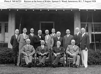 Belknap is standing farthest left in this photograph of retired U.S. Navy admirals and other retirees taken in Jamestown, Rhode Island, on 7 August 1928.