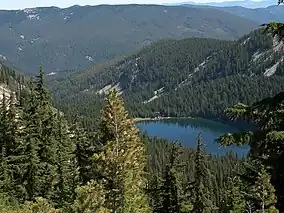 Revett Lake and surrounding mountains and forests from above.