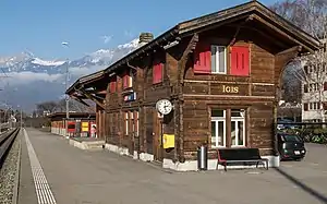 Wooden two-story building with gabled roof