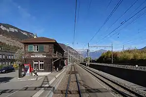 Two-story wooden building with hip roof