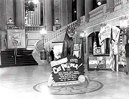 A lobby display with a fake panther a sign reading Cat People