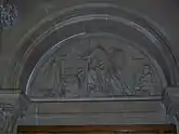 Carved stone tympanum showing Richard Arkwright apparently making calculations alongside experimental models of the water frame