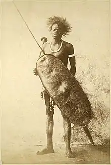 Man holding a large shield