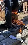 The feet of the statue, with fires set beneath it