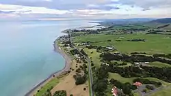 Coastline at Whakatīwai, with Kaiaua in far distance