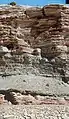 Entrada (orange) and Curtis formations exposed in a road cut, Green River Cutoff Road. They are separated by the J3 unconformity.