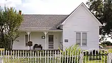 White painted house with garden