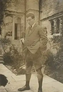 Photograph of Robert Graves in civilian clothes in a garden.