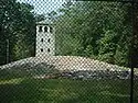 mound and observation tower viewed through protective fence