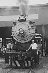 Railroad photographer Roger Puta standing on the pilot steps of No. 5629 at an N&W roundhouse in Indianapolis on May 21, 1966