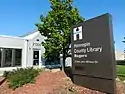 Rogers Library, a small, silver corrugated metal building.