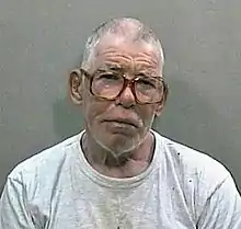 Head shot of elderly man with glasses in a white T-shirt