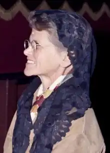 Rosemary Goldie, a middle-aged woman wearing glasses and a dark blue chapel veil, smiles and looks to her right