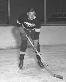 Conacher as a young man posting in full hockey uniform