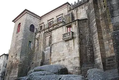 The bishopric dependencies and its castle-like features with towers and austere walls.