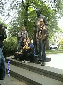 Casually-dressed students, standing and sitting on steps