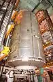 The US laboratory module being moved vertically from the payload transfer container to the Space Shuttle orbiter inside its installation structure