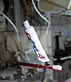 Toothbrush and tube of toothpaste floating in microgravity.