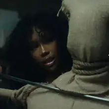 Cover art of "Kill Bill": SZA behind a training dummy, holding her katana towards its neck