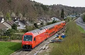 Red train with double-deck coaches