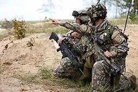 Latvian soldiers using a Heckler & Koch G36 rifle attached with Trijicon ACOG.