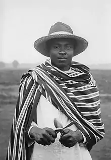 A Sakalava musician in Madagascar wearing a traditional lamba