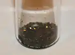 Black lumps in a glass beaker