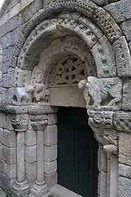 Lateral door of the Monastery of São Pedro das Águias with mythological animals and esoteric motifs.