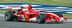 Photo of Michael Schumacher driving a red Ferrari on a race track