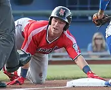 A baseball player in red and gray