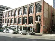 The Scheuerman Block is an example of the Victorian interpretations of the Romanesque Revival frequently applied to buildings erected shortly after the Great Seattle Fire