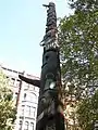 The Pioneer Building is seen here beyond the totem pole that shares its listing in the NRHP.