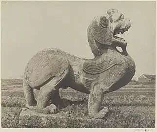 A Chinese Pixiu, (Chinese: 貔貅; pinyin: píxiū; Wade–Giles: P'i-hsiu) head of a Chinese dragon, body of a lion and with a pair of feathered wings, at the tomb of Emperor Wu of Southern Qi (Xiao Ze) in Danyang (near Nanjing, China).