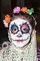 Girl with sugar skull make-up photographed in Mexico City, celebrating Day of the Dead, 2014.