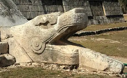 A feathered serpent sculpture at the base of one of the stairways of Kukulcán (El Castillo)