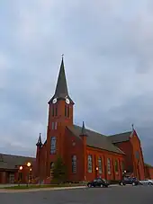 red brick church with a tall spire