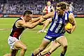 Shaun Higgins fends off Luke Dunstan