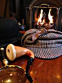 A deerstalker hat made of district or gamekeeper's tweed (contrasting mustard, green and brown checks)